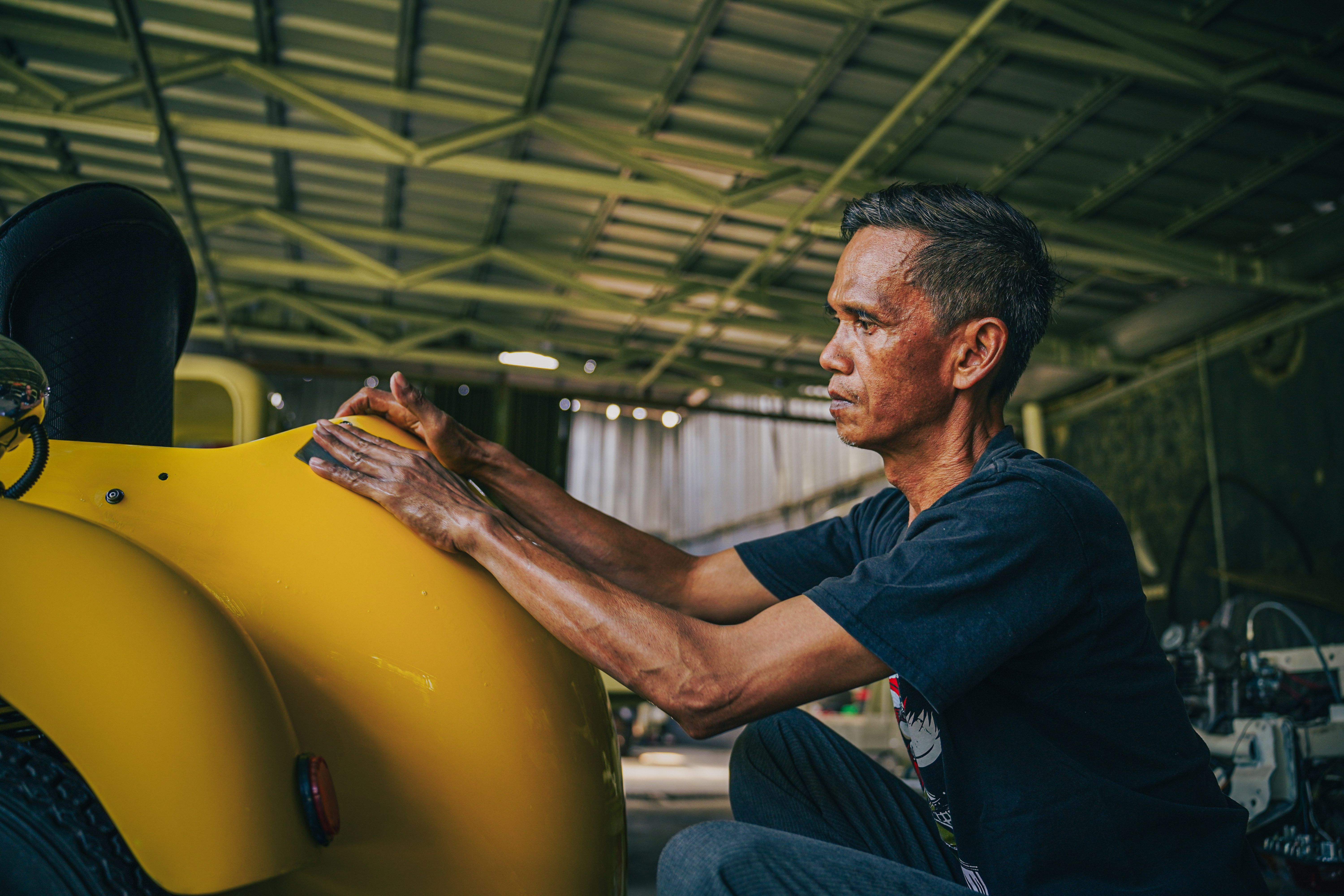 Scooter99 team member focusing on a welding task in the workshop.